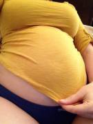 Trying to cover up her round tummy