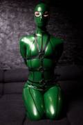 Bound and hooded in green.