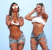 Two bimbos aren't worried that they're suffering numerous wardrobe malfunctions