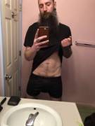 Tall, bearded and taking it off.