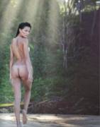 Sensing that she's been spotted, a wild beauty looks about suspiciously as she retreats into the forest