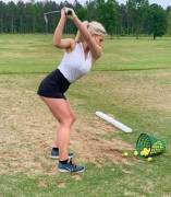 Stroking it in what appears to be a dangerously tiny skirt