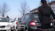 Vanda pissing in a parking lot