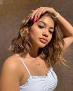 brushing her hair back