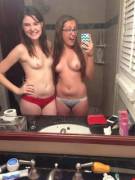 I think the one on the left is slipping a finger to the one on the right.