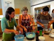 3 Women beating their pies together