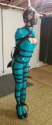 Cobie - Teal latex catsuit, straps, armbinder and muzzle-gag.