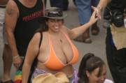 Huge-boobed lady in an orange bikini